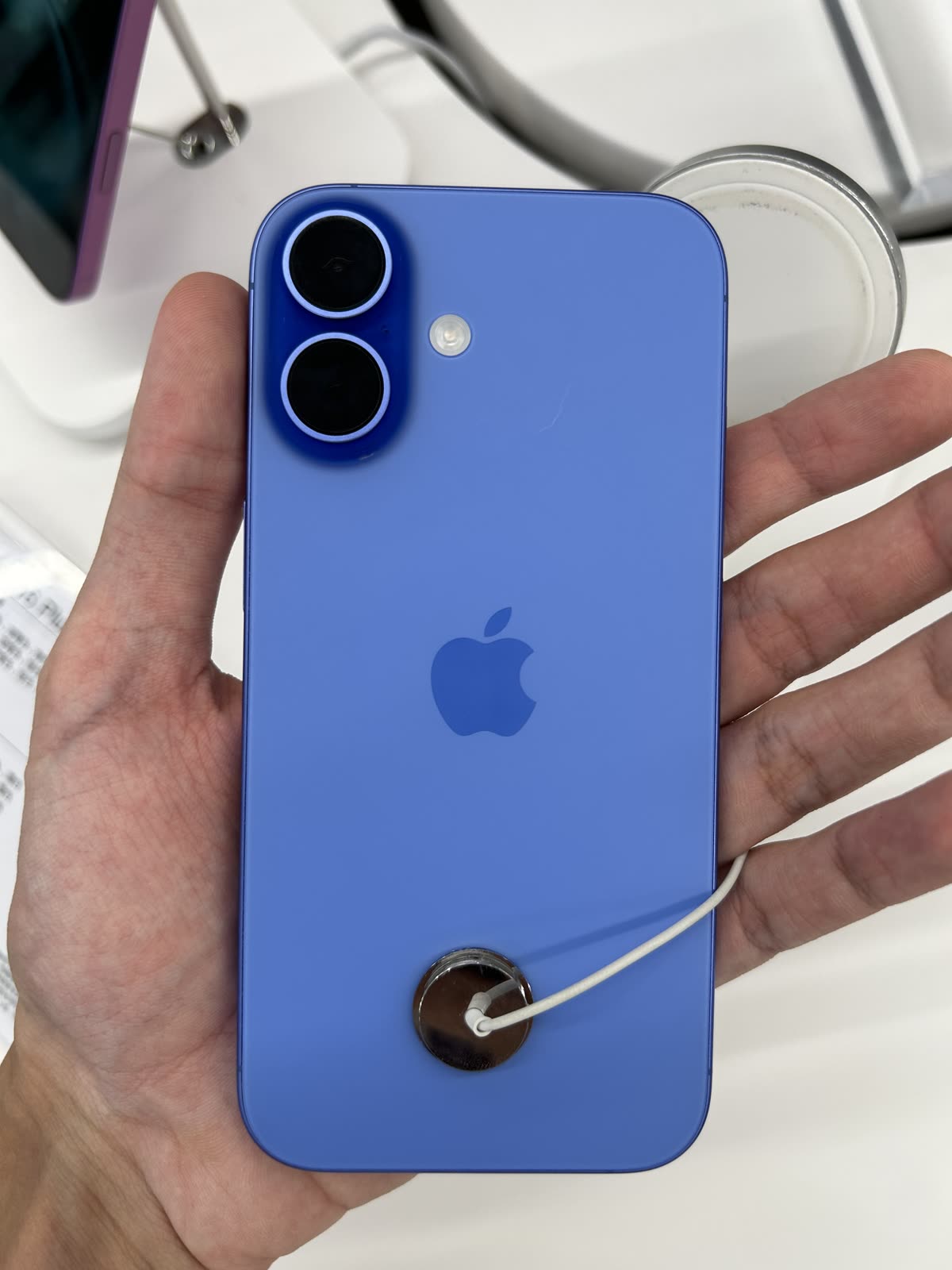 Back view of iPhone 16 Ultramarine — 아이폰16 가격 인상 125만원 — 지금 사면 얼마인가
